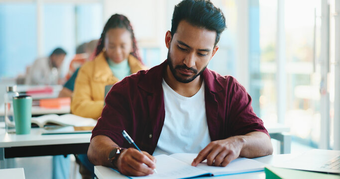 Man, college student and writing with book in classroom for development, learning and scholarship. Person, notes and attention with project, assessment and education with solution at university