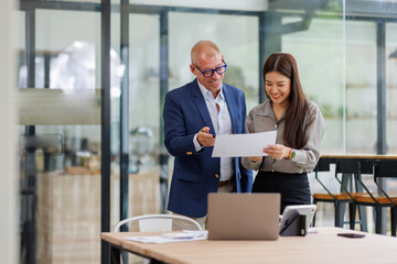 Team of business office worker analyst sitting at desk working on laptop thinking on project plan, analyzing marketing or financial data online, watching elearning webinar.		