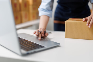 Startup small business entrepreneur or freelance woman working at home office, packaging and...