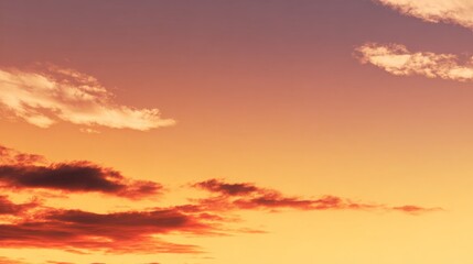 Fototapeta premium Vibrant sunset over a tranquil sky filled with warm colors and soft clouds creating a serene evening atmosphere