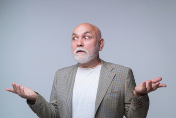 Confused senior man with shocked facial expression. Confused pensioner man. Elderly male showing...