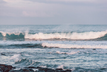 Scenic view of wave breaking near the shore at dusk with a hint of pink in the sunlight, Griffith Island, Port Fairy, Great Ocean Road, Victoria, Australia