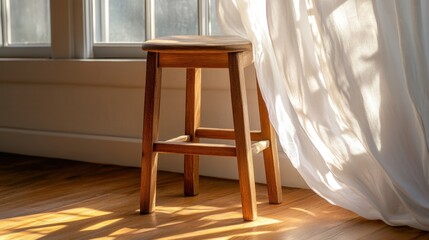 Rustic wooden stool with flowing white fabric, sunlight streaming through window