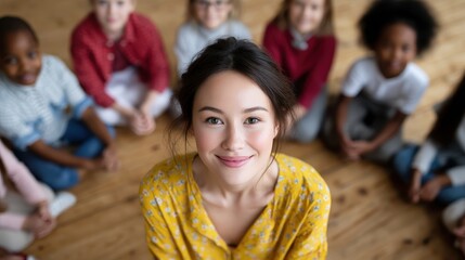 Fototapeta premium Smiling woman surrounded by diverse children in a classroom setting.