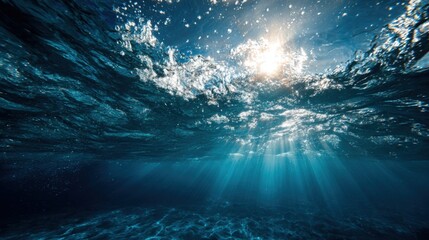Fototapeta premium Sunlight filters through the surface of the ocean, illuminating the water and creating beautiful patterns. The scene captures a peaceful underwater atmosphere with shimmering rays bending.