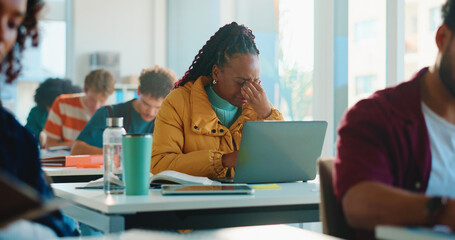 Woman, college student and headache in classroom for education, stress or laptop at academy. Girl,...