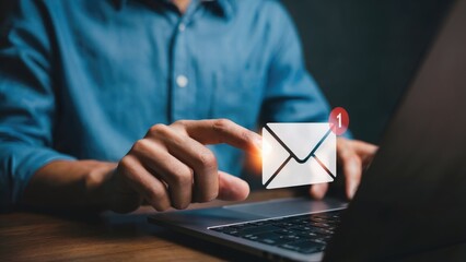 Man receives new unread message on laptop with finger hovering over the email notification