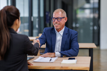 Happy Two business handshake to congratulate success. Successful Asian business people working together team.
