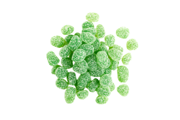 a pile of green gummy bears on a white surface