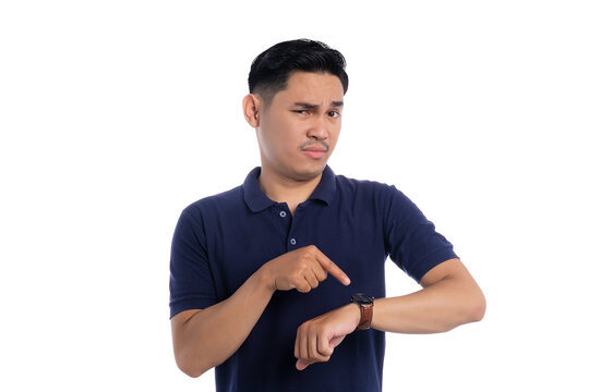 Serious man pointing at wristwatch while looking impatient isolated on transparent background