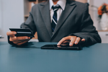 Online payment,businessman hands holding credit card and using  laptop for online shopping. Cyber Monday Concept