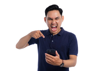 Angry man shouting and pointing at smartphone while looking frustrated isolated on transparent background