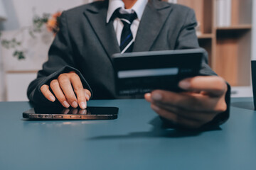 Online payment,businessman hands holding credit card and using  laptop for online shopping. Cyber Monday Concept