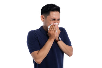 Sick man sneezing into tissue with eyes closed showing flu or allergy symptoms isolated on...