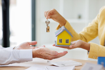 Estate business agent giving house keys to client after signing agreement contract real estate with...