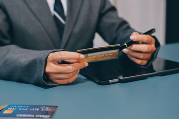 Online payment,businessman hands holding credit card and using  laptop for online shopping. Cyber Monday Concept