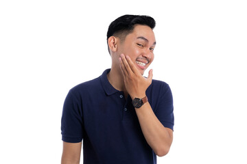 Playful smiling man touching face with one hand while showing bashful expression isolated on...
