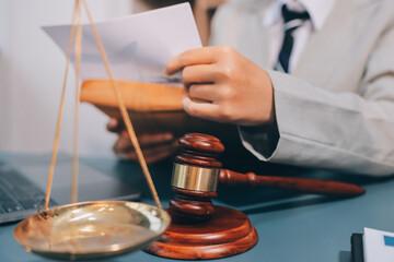 Judge gavel with Justice lawyers having team meeting at law firm background. Concepts of Law and...