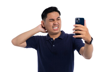 Frustrated man scratching neck while looking at smartphone with confused and annoyed expression isolated on transparent background