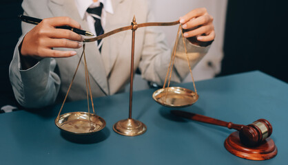 Judge gavel with Justice lawyers having team meeting at law firm background. Concepts of Law and...