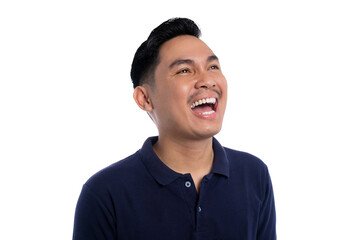 Happy young man laughing joyfully while looking up wearing navy blue polo shirt isolated on transparent background