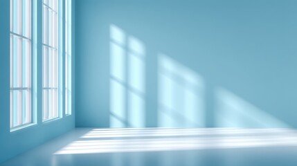 Obraz premium Spacious room features light blue walls and large windows. Late afternoon sunlight creates soft shadows, emphasizing the tranquility of the area, perfect for relaxation or creativity.