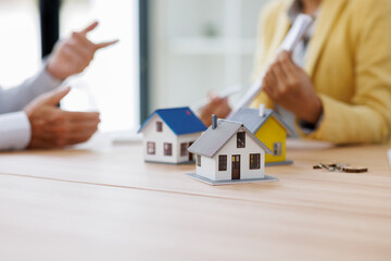House model with business Mature and Asian female working at office,signs a purchase contract or...