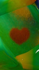 Heart shape pattern behind hexagon grid on colored geometric background