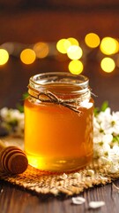 Honey jar on rustic surface with flowers