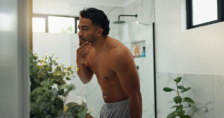 Bathroom, grooming and man with beard, house and inspection of fresh shave, self care and...
