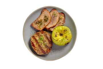 a plate with meat apples and a green apple