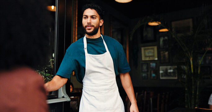 Entrance, coffee shop and waiter with customer for welcome, greeting or hospitality service. Industry, entrepreneur and male small business owner with consumer at doorway of restaurant or cafe.
