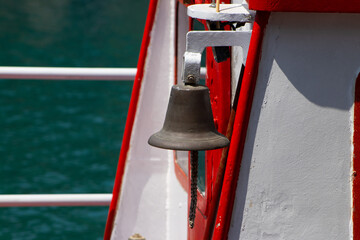 Ship's Bell Against Turquoise Water