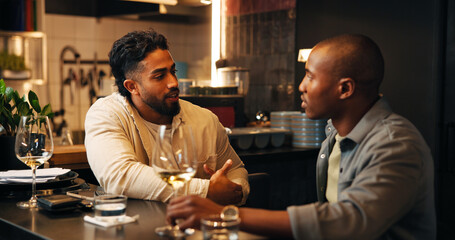 Friends, men and talking with wine in restaurant for social gathering, weekend break and hangout....