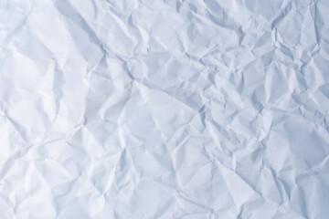 A minimal and clean crumpled white paper texture. Perfect as a neutral background for graphic design, mockups, or layout templates.