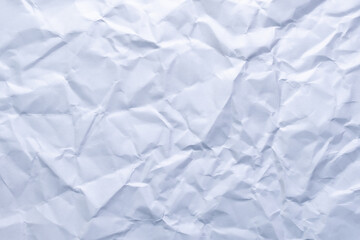 A minimal and clean crumpled white paper texture. Perfect as a neutral background for graphic design, mockups, or layout templates.