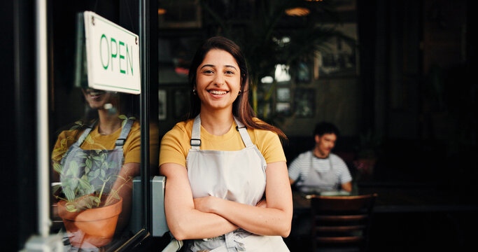 Happy woman, portrait or open with confidence in cafe for small business startup or welcome. Female person, waiter or owner with smile or arms crossed by door or ready for service in coffee shop - Powered by Adobe
