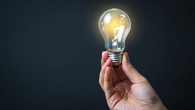 Holding a glowing light bulb with question marks symbolizing ideas solutions and problem solving on a dark background
