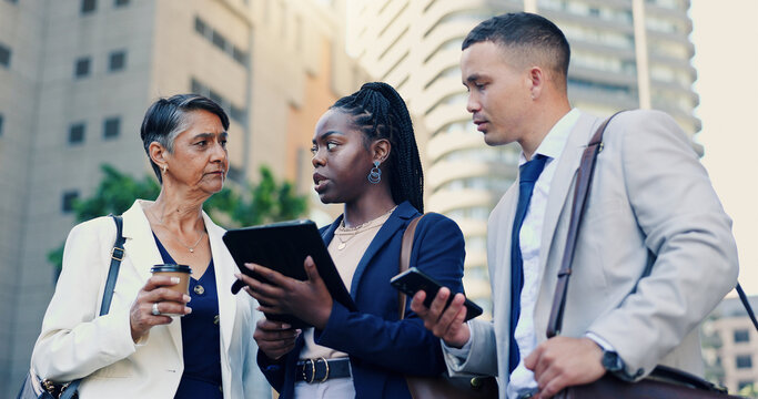 Tablet, conversation and business people in city, teamwork and worry with inflation news. Group, financial agency and employees in street, fintech and stress with investment report or risk management - Powered by Adobe