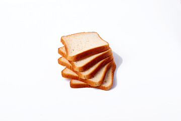 A stack of four slices of bread on a white background. The bread is toasted and looks fresh