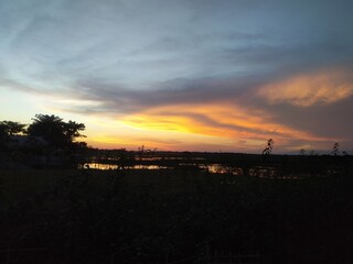 Breathtaking Sunset over the Water near the Horizon. A Beautiful Landscape Showing the Skies and...