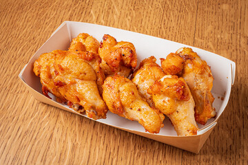 Succulent fried chicken wings served in a cozy setting, inviting a taste of savory delight