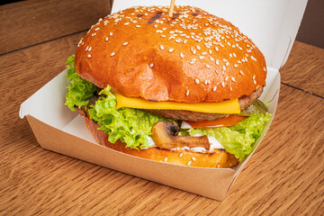 A mouthwatering gourmet burger features crispy lettuce, cheese, and savory mushrooms in a warm bun