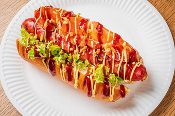 A colorful hotdog with ketchup, mustard, and toppings awaits you on a warm day outside