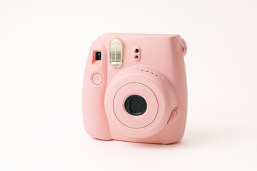 Pink camera on white background.