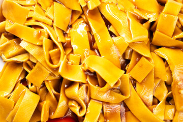 Tofu noodles on dark background. Soy cheese. Vegan food.