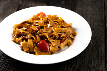 Tofu noodles on dark background. Soy cheese. Vegan food.