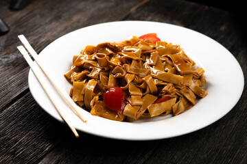 Tofu noodles on dark background. Soy cheese. Vegan food.