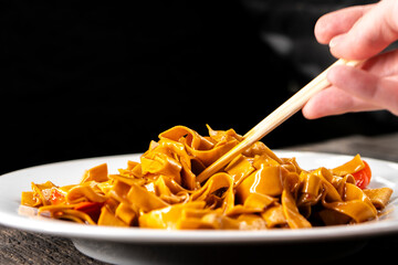 Tofu noodles on dark background. Soy cheese. Vegan food.