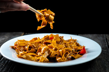 Tofu noodles on dark background. Soy cheese. Vegan food.